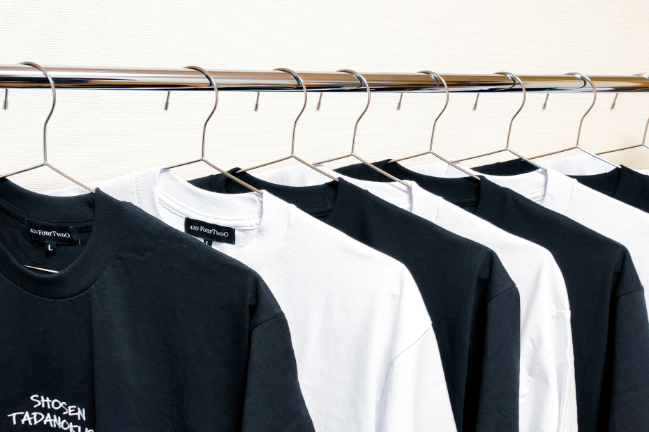 Black and white shirts hanging on a rack