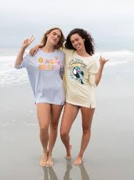 2 girls posing in their graphic t-shirts at the beach