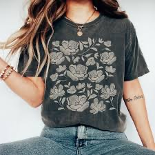 A graphic t-shirt with a pretty floral design on it.
